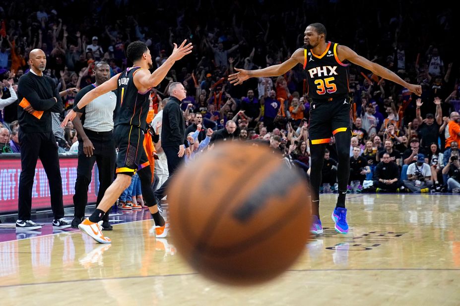 Devin Booker, left, celebrates a basket with his Phoenix Suns teammate, Kevin Durant, during an NBA playoff game against Denver on Friday, May 5.
