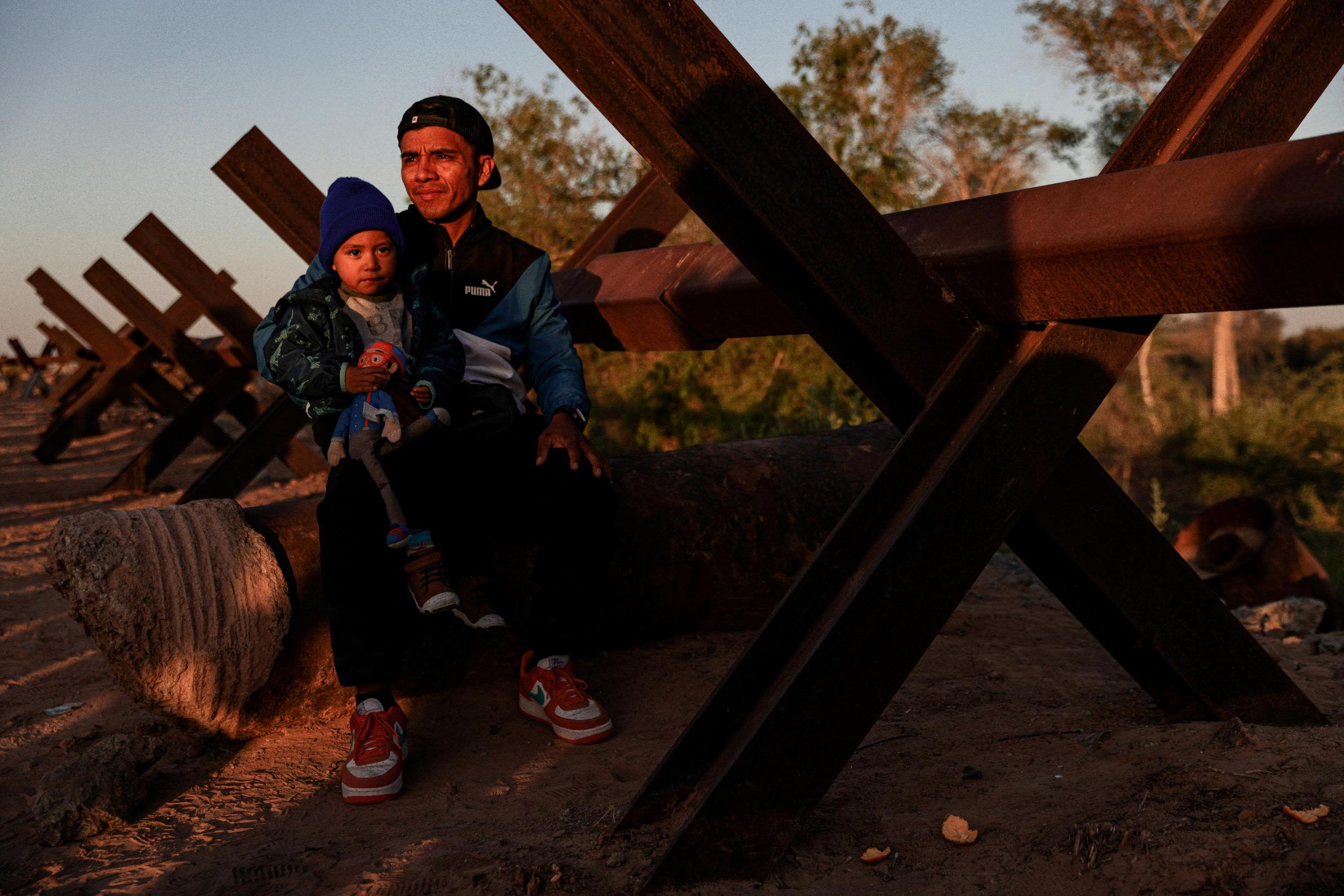 Erick Torres and his son Benjamin, migrants from Peru, wait to be processed by US Border Patrol agents in Yuma on May 11.