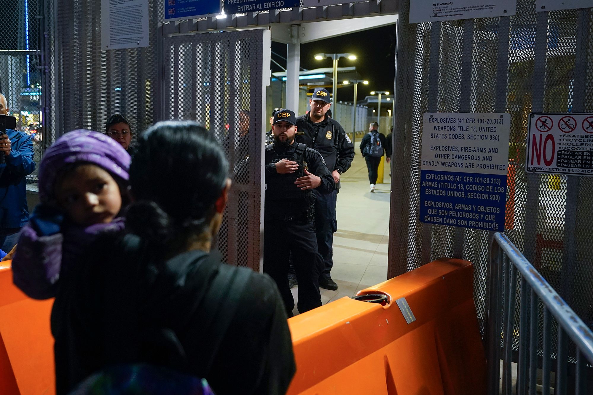 Paula, a woman from Guatemala, holds her daughter as she asks US border officials about the new asylum rules at the San Ysidro Port of Entry, between San Diego and Tijuana, Mexico, on Thursday, May 11.