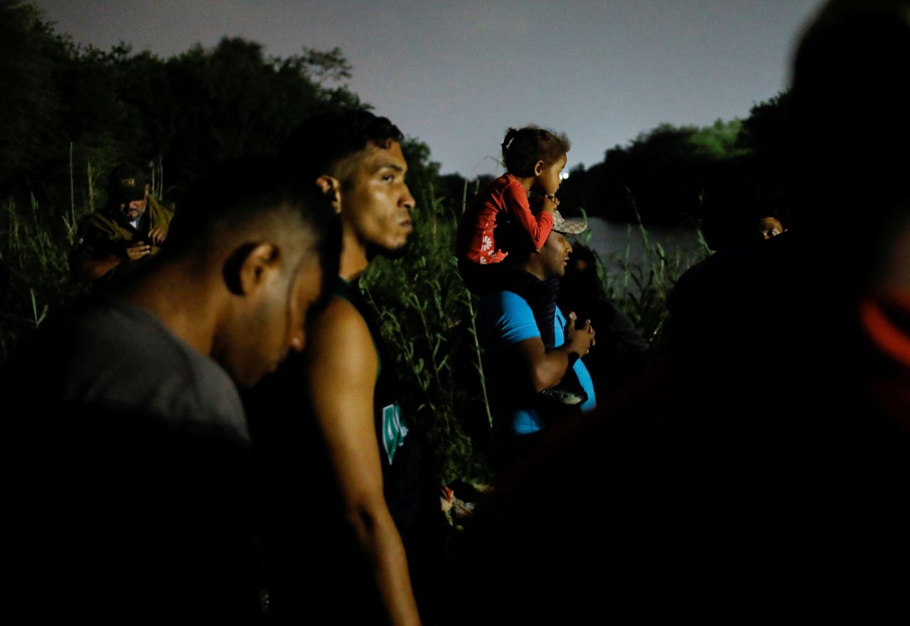 Migrants gather on the banks of the Rio Grande in Matamoros on May 11 as they get ready to cross the border to turn themselves in.