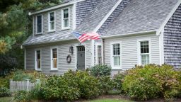 CHATHAM, CAPE COD:  American flag flying and traditional wooden timber clapboard architecture house near Cockle Cove at Chatham, Cape Cod, New England, United States.  (Photo by Tim Graham/Getty Images)