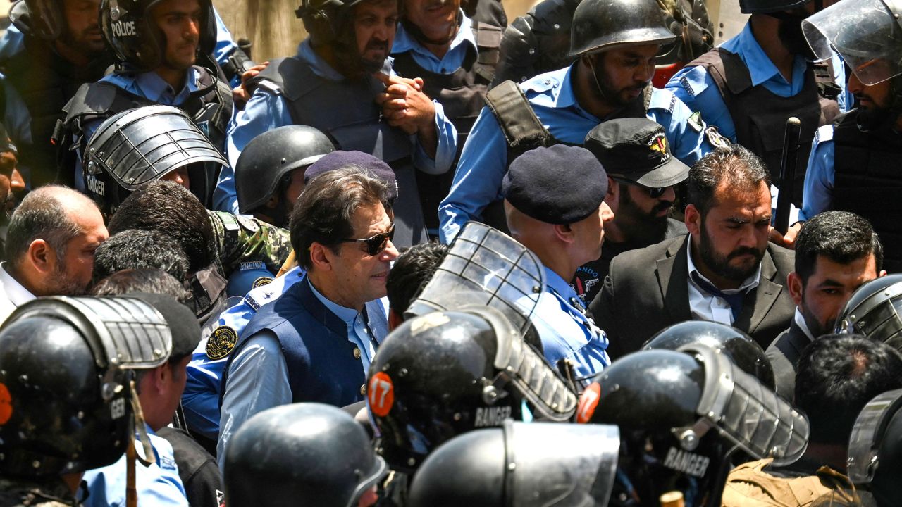Policemen escort Pakistan's former prime minister, Imran Khan, as he arrives at the High Court in Islamabad, Pakistan on May 12, 2023. 