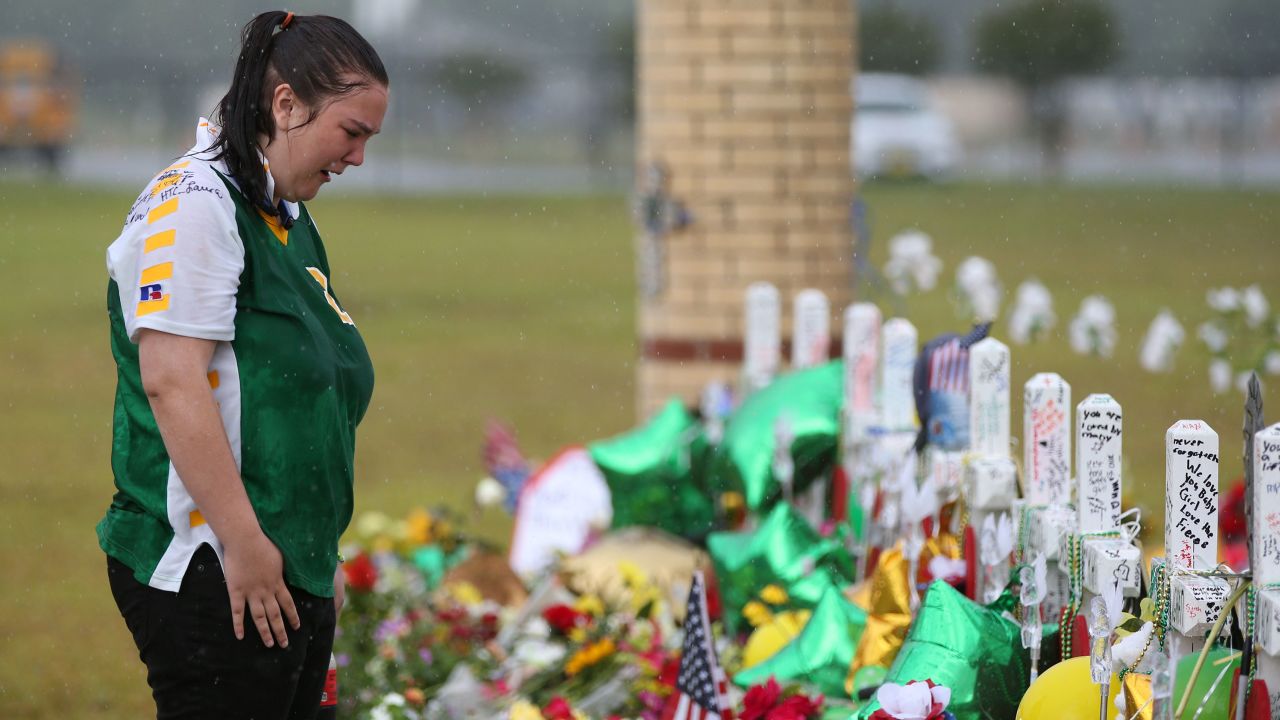 Santa Fe High School student Sierra Dean mourns the death of her friends killed in a recent shooting at a makeshift memorial left in their memory at Santa Fe High School in Santa Fe, Texas, U.S., May 23, 2018.