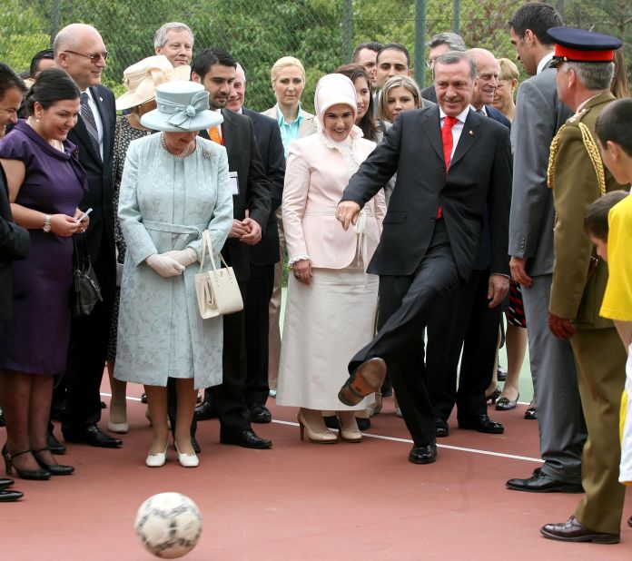 Britain's Queen Elizabeth II watches Erdogan kick a football during a royal garden party at the British Embassy in Ankara in 2008. It was the final day of the Queen's state visit to Turkey.