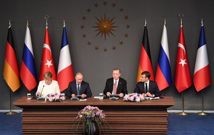 From left, German Chancellor Angela Merkel, Russian President Vladimir Putin, Erdogan and French President Emmanuel Macron take part in a summit in Istanbul that was called in October 2018 to find a lasting political solution to the civil war in Syria.