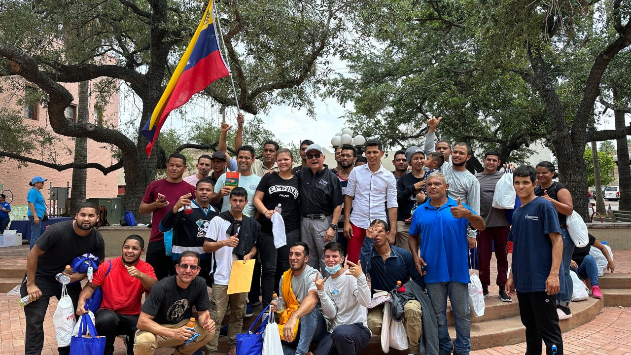 Pastor Carlos Navarro of Iglesia Batista West Brownsville poses with a group of Venezuelan migrants who've just arrived in his city.