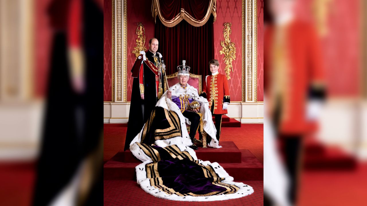In this photo released by Buckingham Palace on Friday, May 12, 2023, Britain's King Charles III, the Prince of Wales and Prince George pose for a photo, on the day of the coronation, on May 6, 2023, in the Throne Room at Buckingham Palace, London.