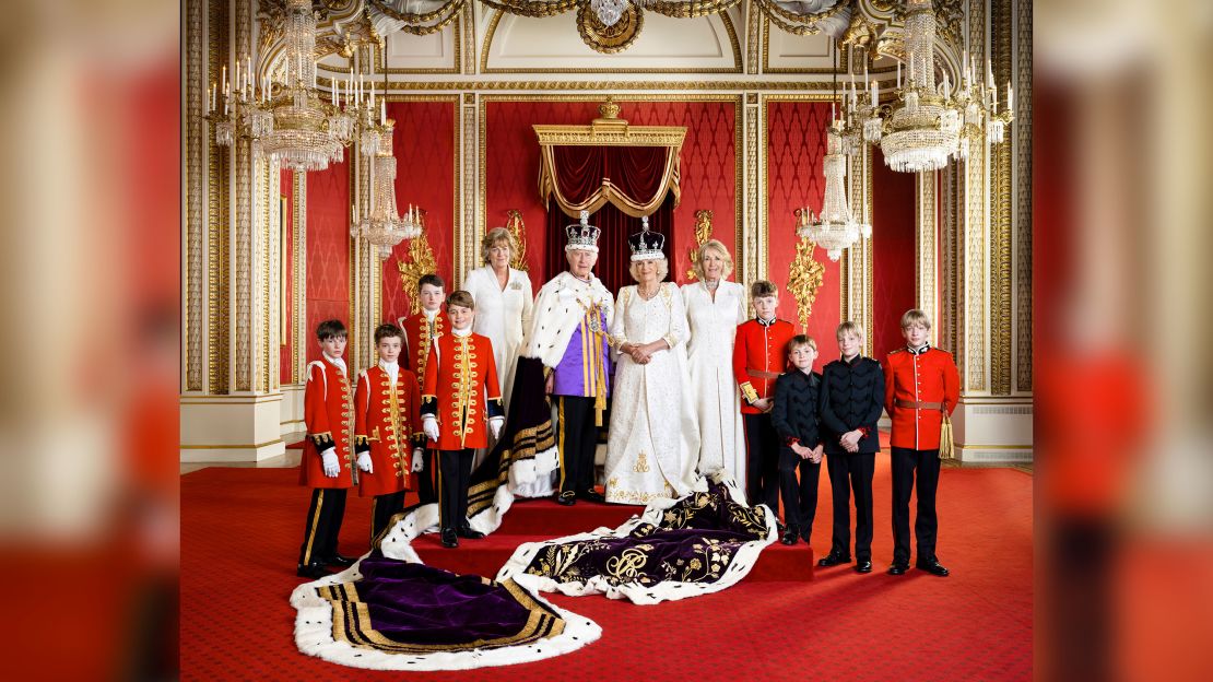 In this photo released by Buckingham Palace on May 12 Britain's King Charles III and Queen Camilla pose for a photo with their Pages of Honour and Ladies in Attendance on the day of the coronation, May 6, in the Throne Room at Buckingham Palace, London.