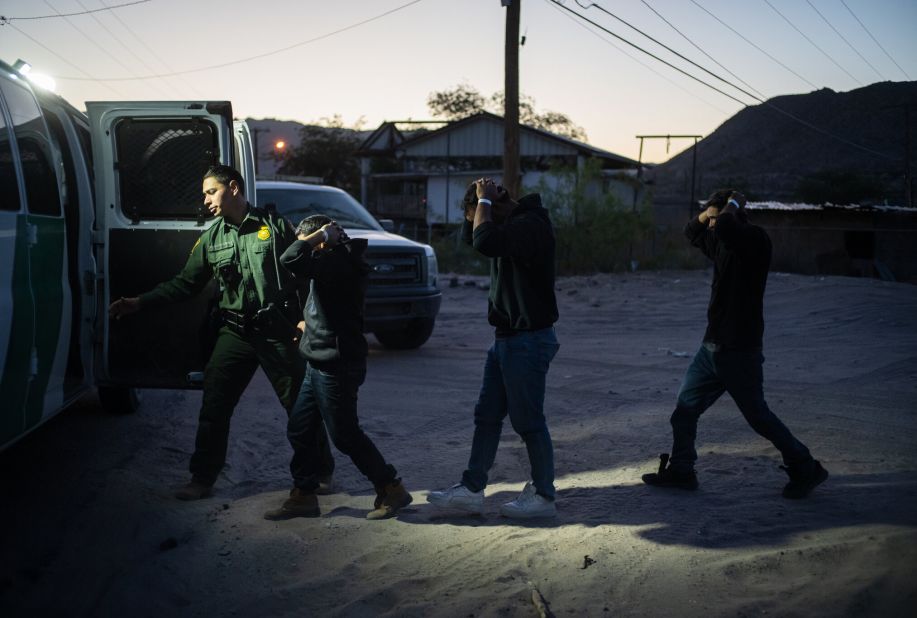 A group of men from El Salvador are detained by US Border Patrol agents after crossing the border near Sunland Park, New Mexico, on May 12.