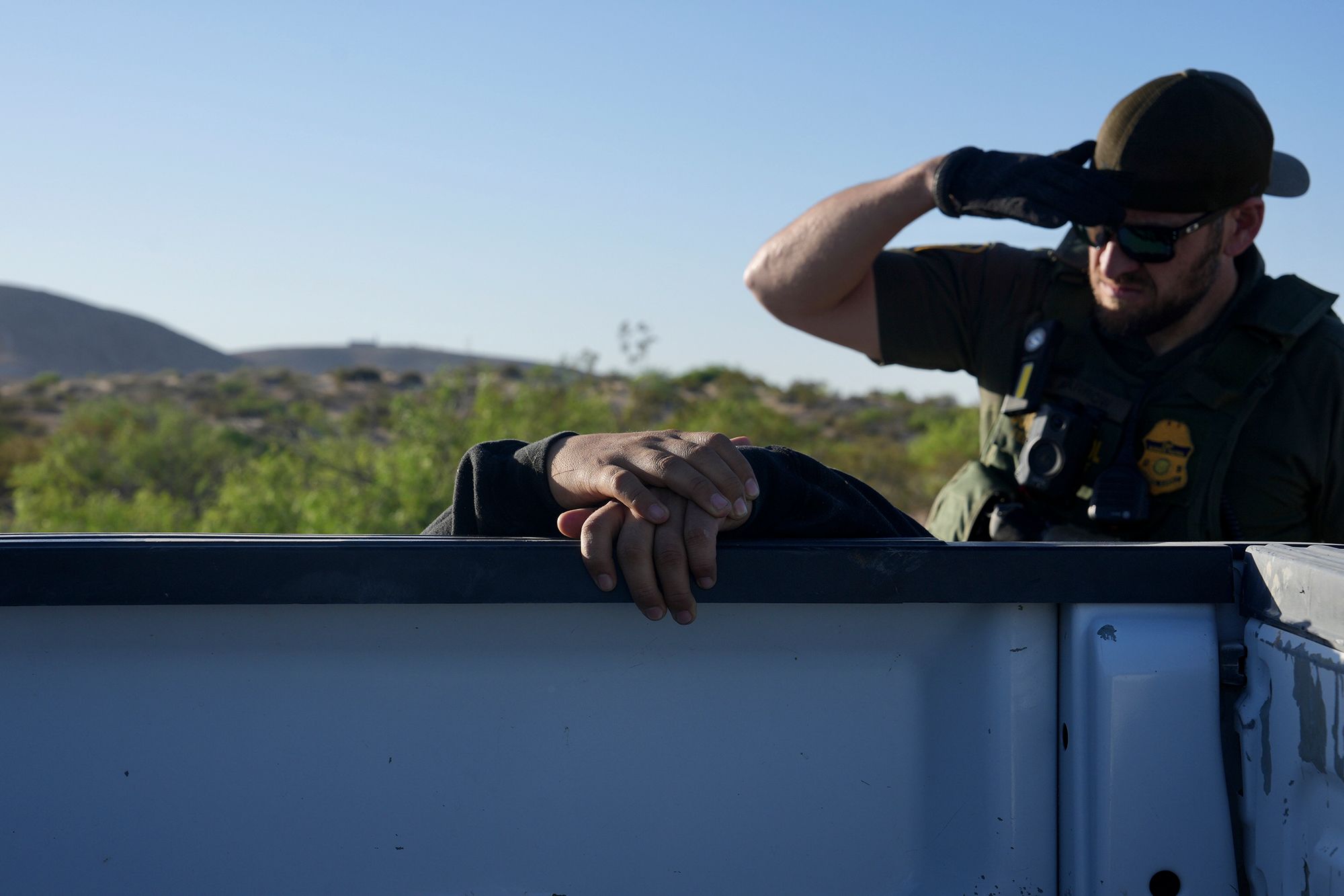 A US Border Patrol agent searches a man from Mexico who crossed the border illegally near Sunland Park on May 12.