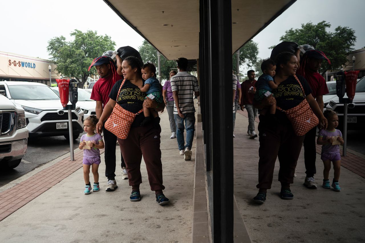 Ligia Garcia her husband, Robert Castellon, walk with their children Raibelis,Castellon and Romer Castellon to buy food after they were processed by US border officials in McAllen, Texas, on May 12.