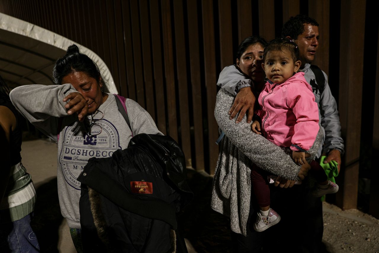 A group of migrants from Peru react after crossing the border just a few minutes before the lifting of Title 42 in Yuma, Arizona, on May 11.