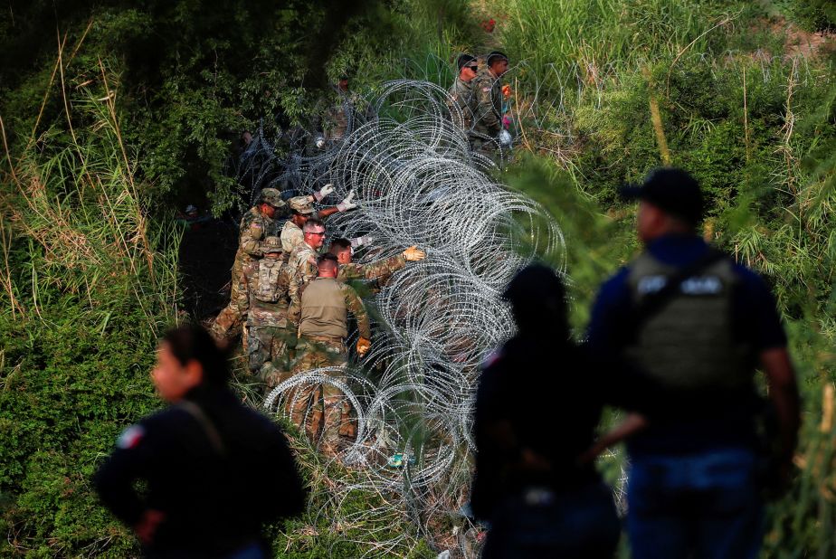 Texas National Guard soldiers place more razor wire on the banks of the Rio Grande in Matamoros on May 11.