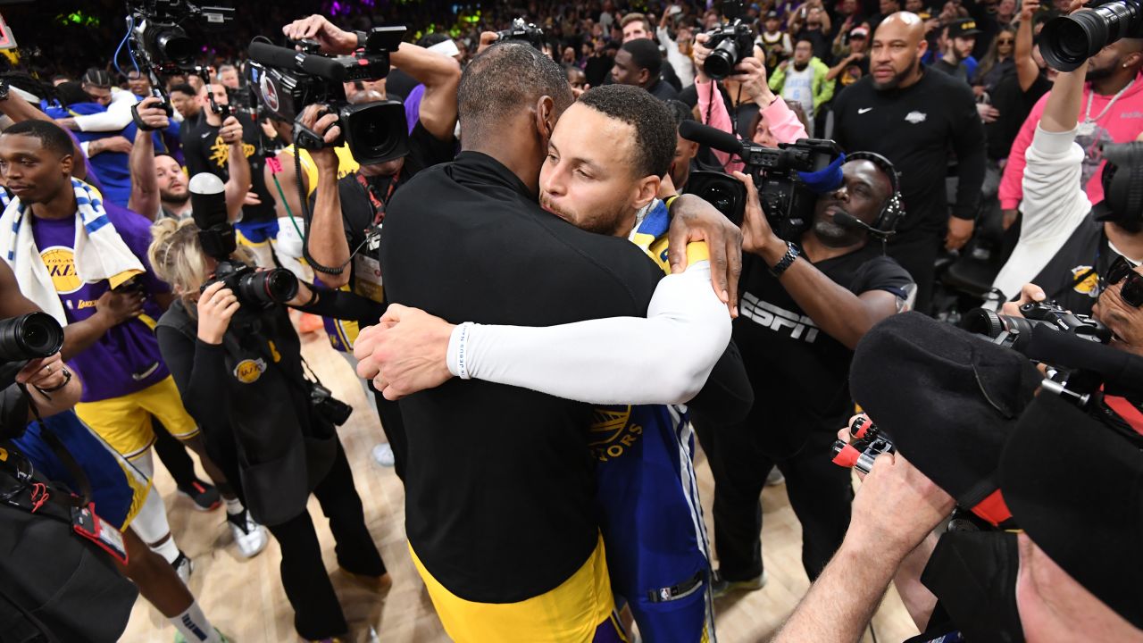 LeBron James and Stephen Curry (right) embrace after the game. 