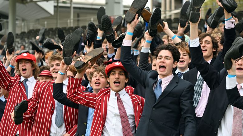 Eton schoolboys cheer on their team from the grandstand during the Eton v Harrow cricket match at Lord's Cricket Ground in London on May 12, 2023. The Lord's 'hush', the almost reverential silence in which a Test match at the 'Home of Cricket' often takes place was notably absent during the Eton v Harrow match on Friday.
