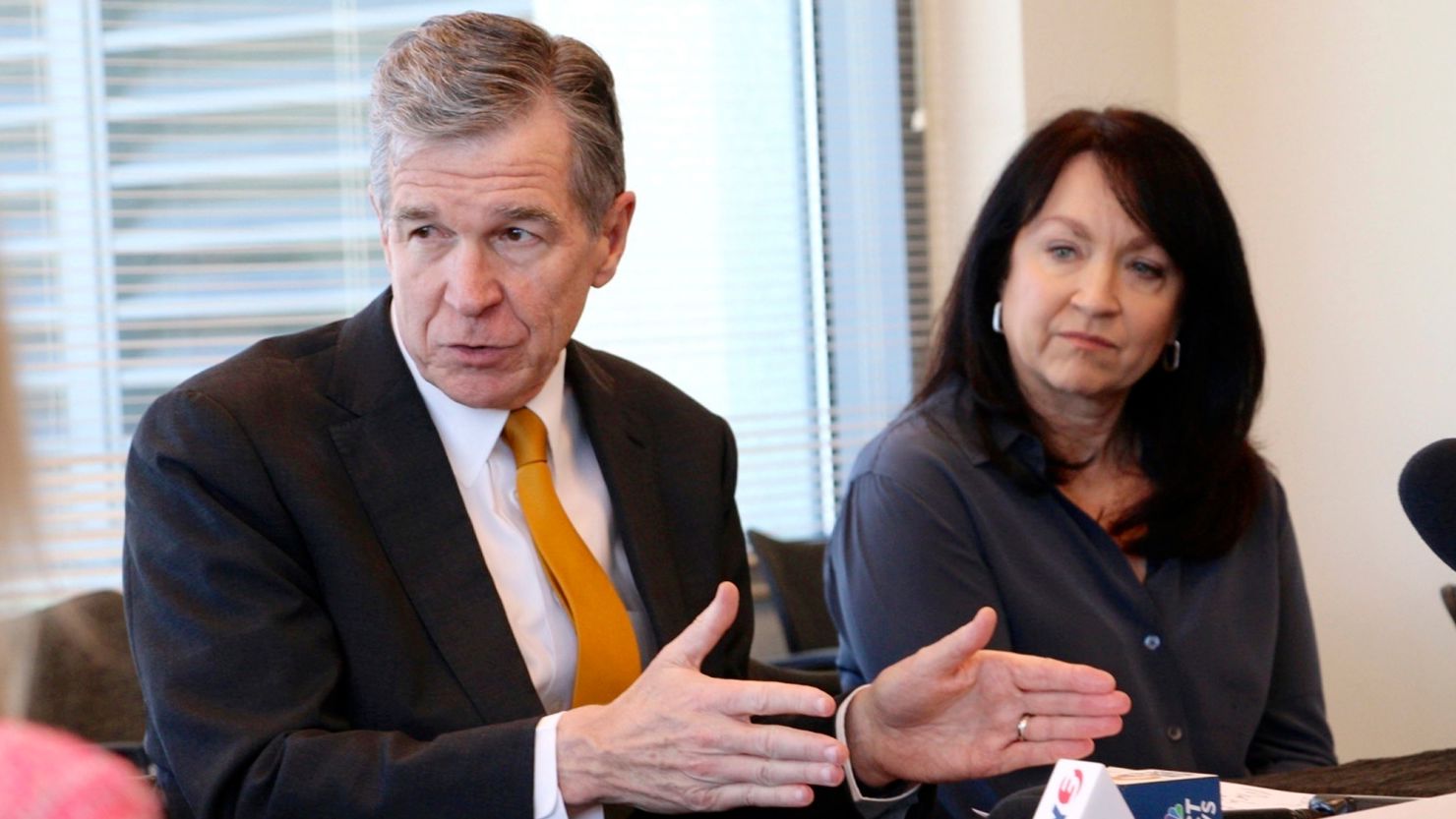 North Carolina Gov. Roy Cooper, left, and Planned Parenthood South Atlantic CEO Jenny Black speak with doctors at a forum about new abortion restrictions, Wednesday, May 10, 2023.