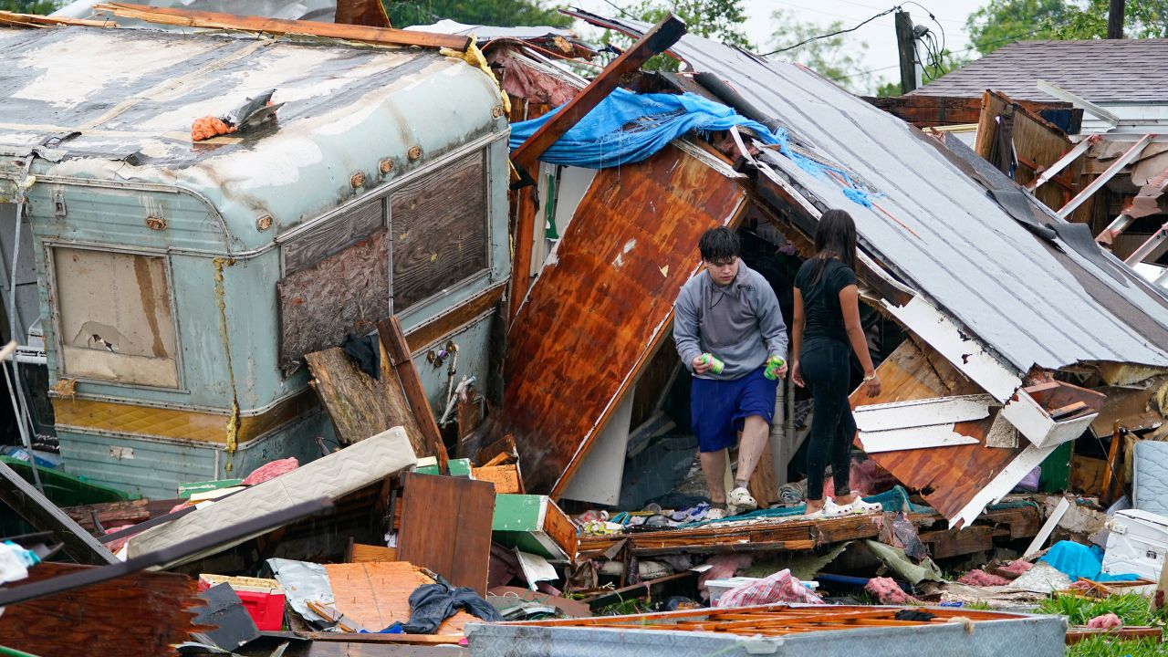 People salvage items from a home after a tornado hit Saturday, May 13, 2023, in the unincorporated community of Laguna Heights, Texas, near South Padre Island.
