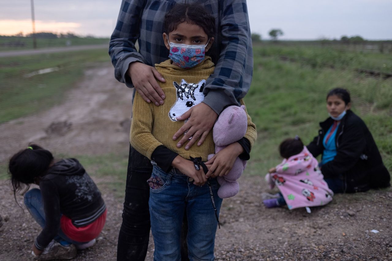 Alison, a 6-year-old asylum-seeking migrant from Honduras, is held by her mother while they wait to be transported to a US Border Patrol processing facility in La Joya, Texas, on May 13.
