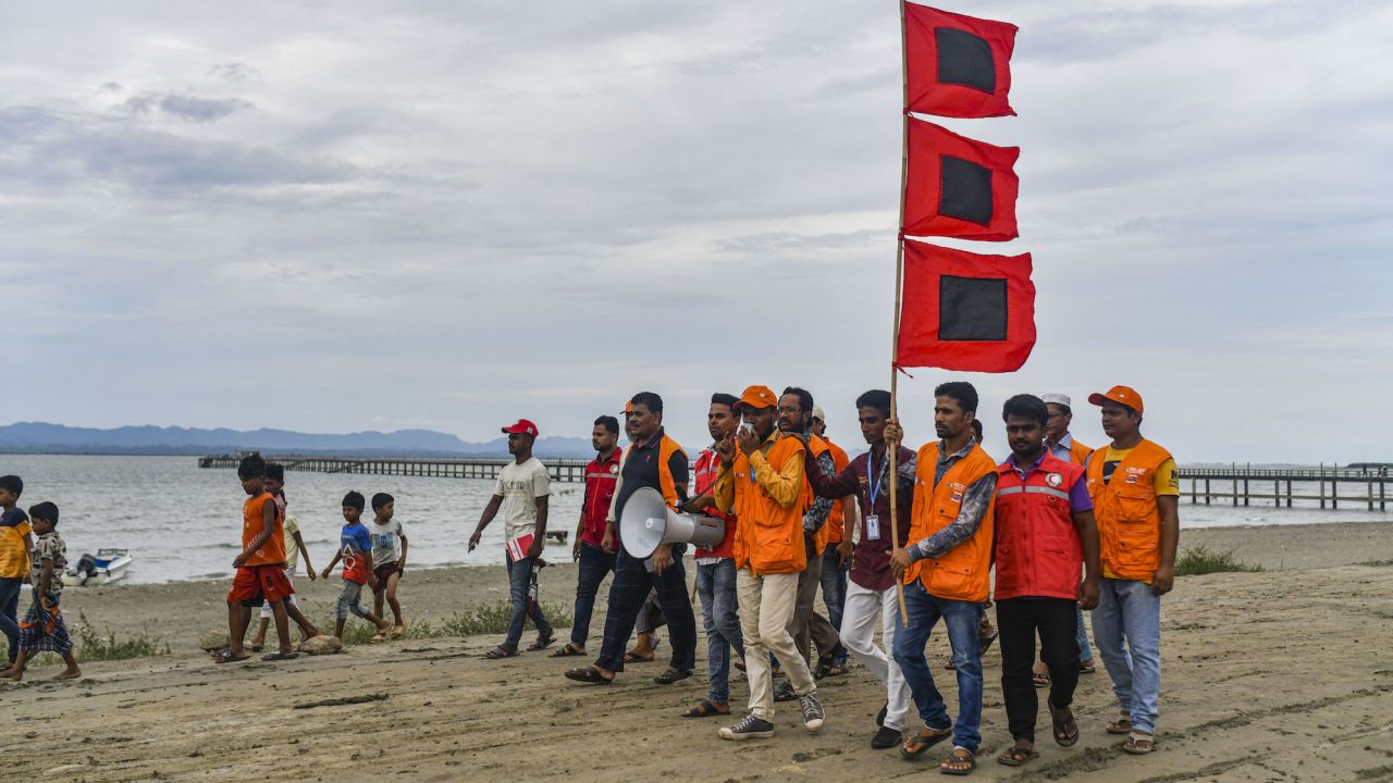 Bangladeshi volunteers warn people to leave their homes and take shelter ahead of Cyclone Mocha's landfall in Cox's Bazar, Bangladesh on May 13, 2023.