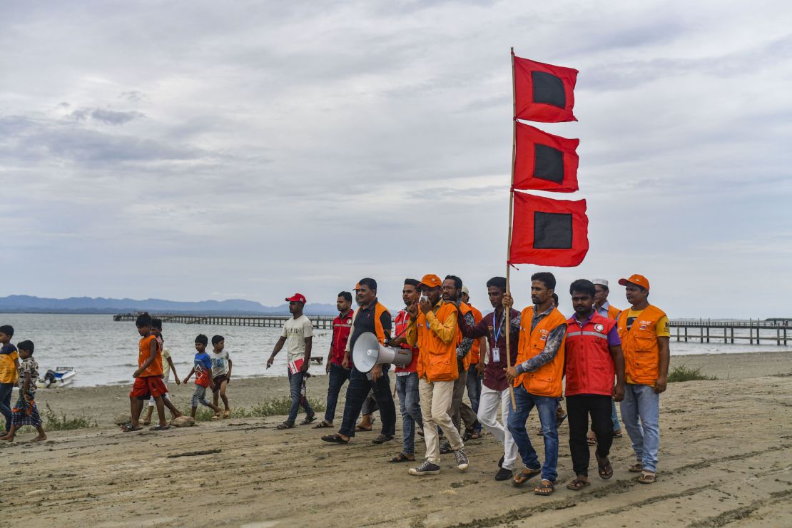 Bangladeshi volunteers warn people to leave their homes and take shelter ahead of Cyclone Mocha's landfall in Cox's Bazar, Bangladesh on May 13, 2023.