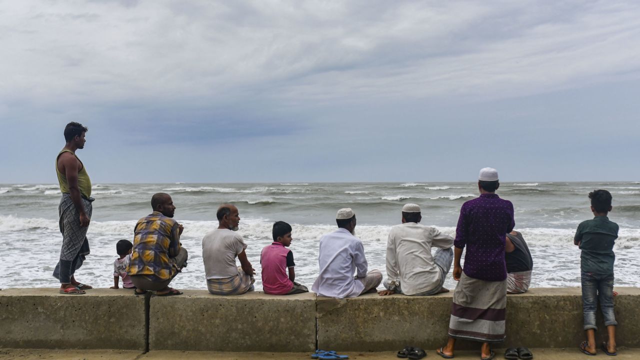 People gather at Shahpori island beach in Teknaf ahead of Cyclone Mocha's landfall in Cox's Bazar, Bangladesh on May 13, 2023.