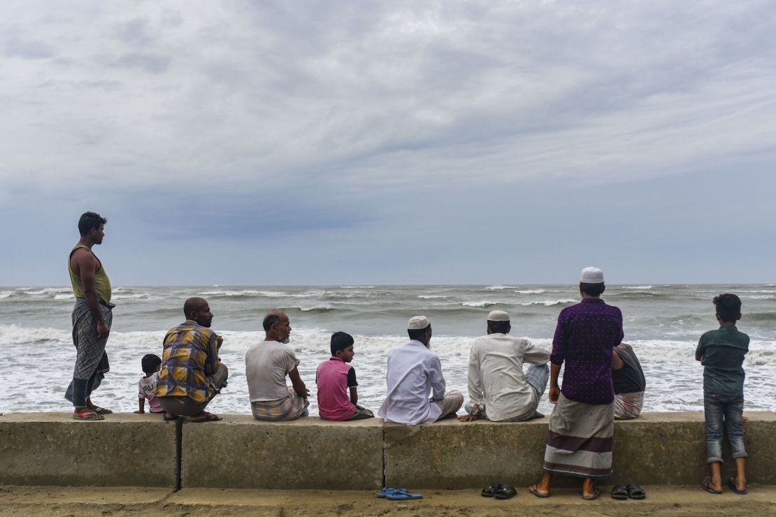 People gather at Shahpori island beach in Teknaf ahead of Cyclone Mocha's landfall in Cox's Bazar, Bangladesh on May 13, 2023.