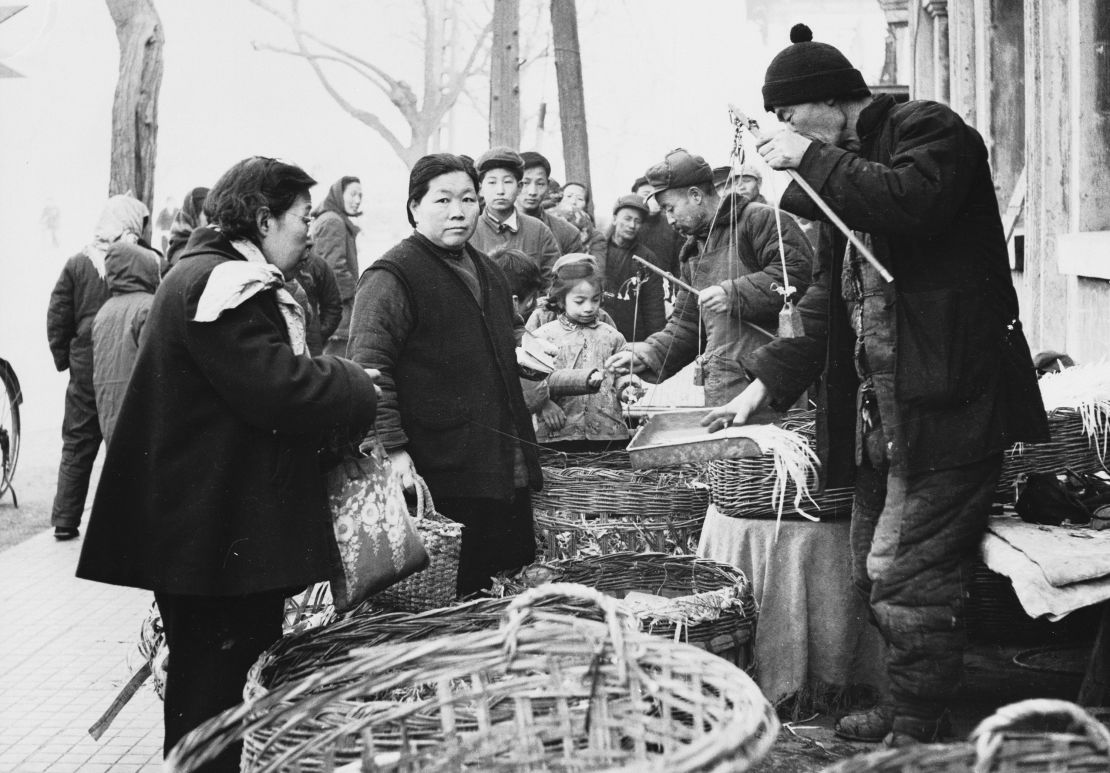 May 1959: Customers buying fresh vegetables from a market in China's capital. 