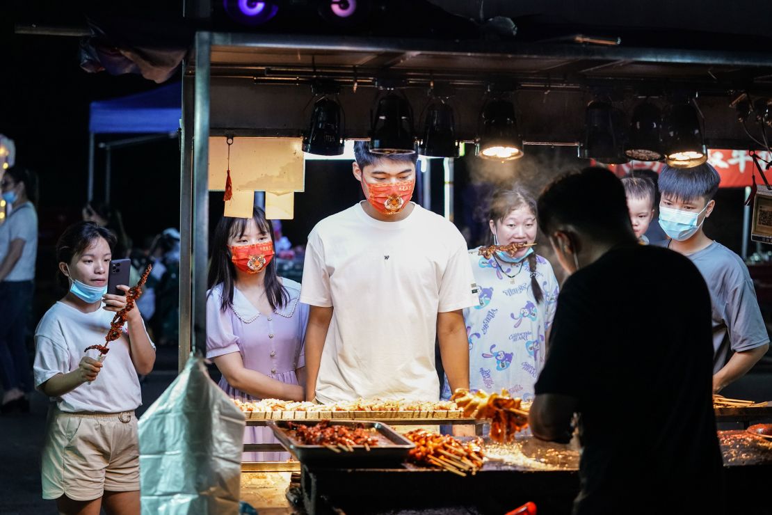 People waiting to buy snacks at a night market in Nanning, capital of China's Guangxi region, in June 2022. 