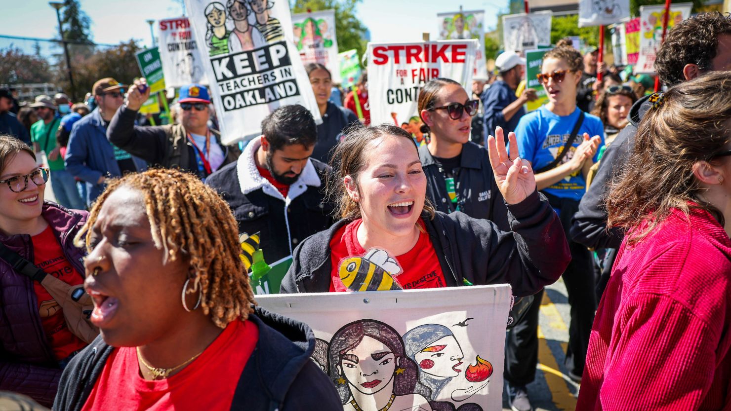 Special education teacher Olivia Michelson, center, along with fellow Oakland Unified School District teachers, students and parents picket outside La Escuelita Elementary School in Oakland, California, last week.