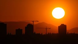 The sun sets over the University District in Seattle, Saturday, May 13, 2023. Saturday's temperatures reached record-breaking highs for several cities across western Washington.