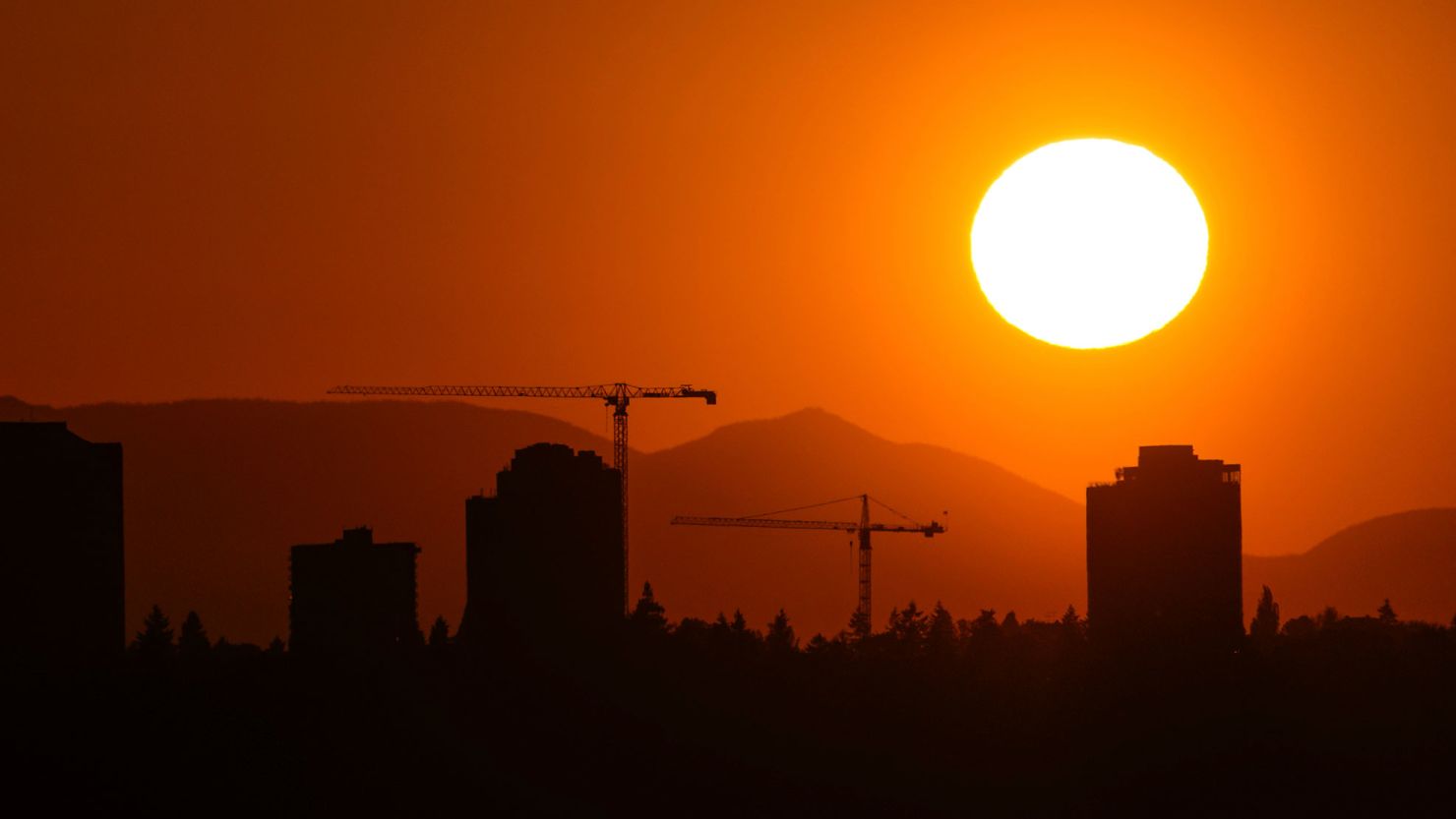 The sun sets over the University District in Seattle, Saturday, May 13, 2023. Saturday's temperatures reached record-breaking highs for several cities across western Washington.