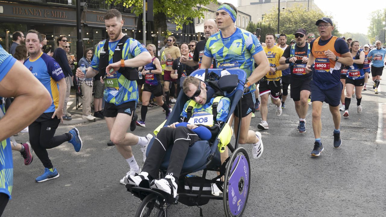 Sinfield pushes Burrow during the Rob Burrow Leeds Marathon.
