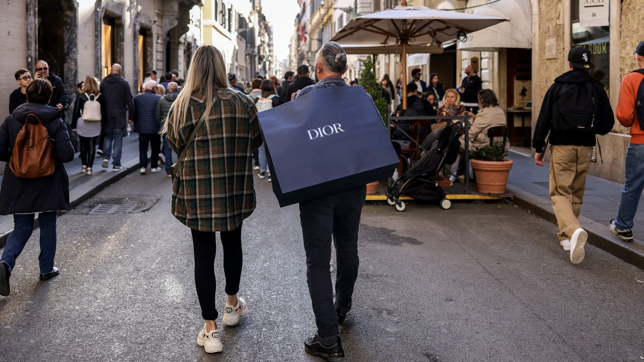 A pedestrian carries a Dior branded shopping bag in downtown Rome, Italy, on Tuesday March 28, 2023. Italy is due to report their latest inflation figures on Friday. Photographer: Alessia Pierdomenico/Bloomberg via Getty Images