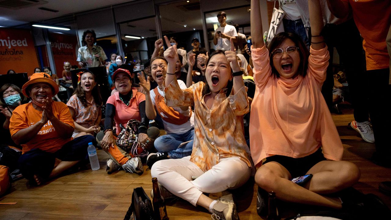 Supporters of the Move Forward Party react as they watch results come in at the party headquarters in Bangkok on May 14, after polls closed in Thailand's general election. 