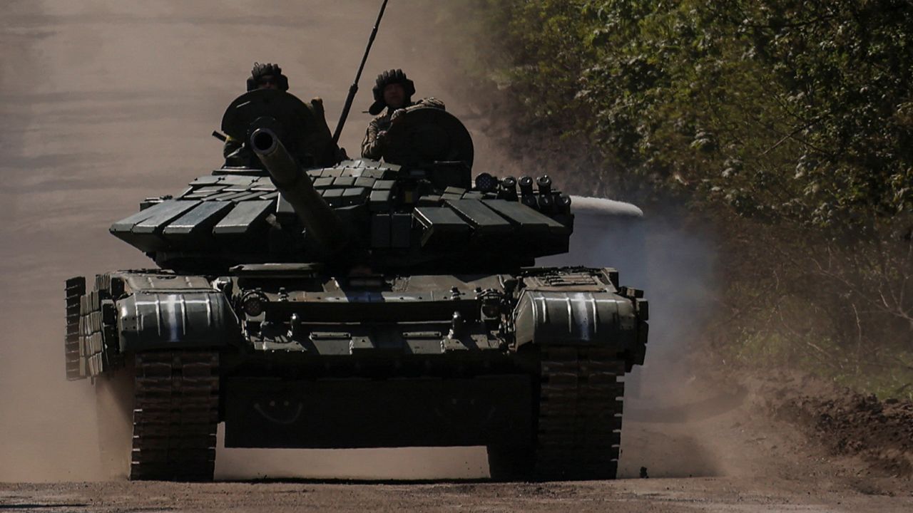 Ukrainian servicemen ride atop a tank on a road to the frontline town of Bakhmut, amid Russia's attack on Ukraine, in Donetsk region, Ukraine May 12, 2023. 