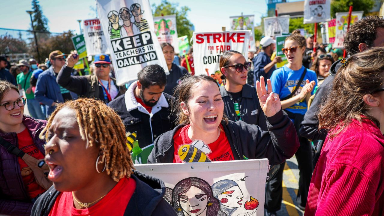Special education teacher Olivia Michelson, center, along with fellow Oakland Unified School District teachers, students and parents picket outside La Escuelita Elementary School in Oakland, California on May 10.