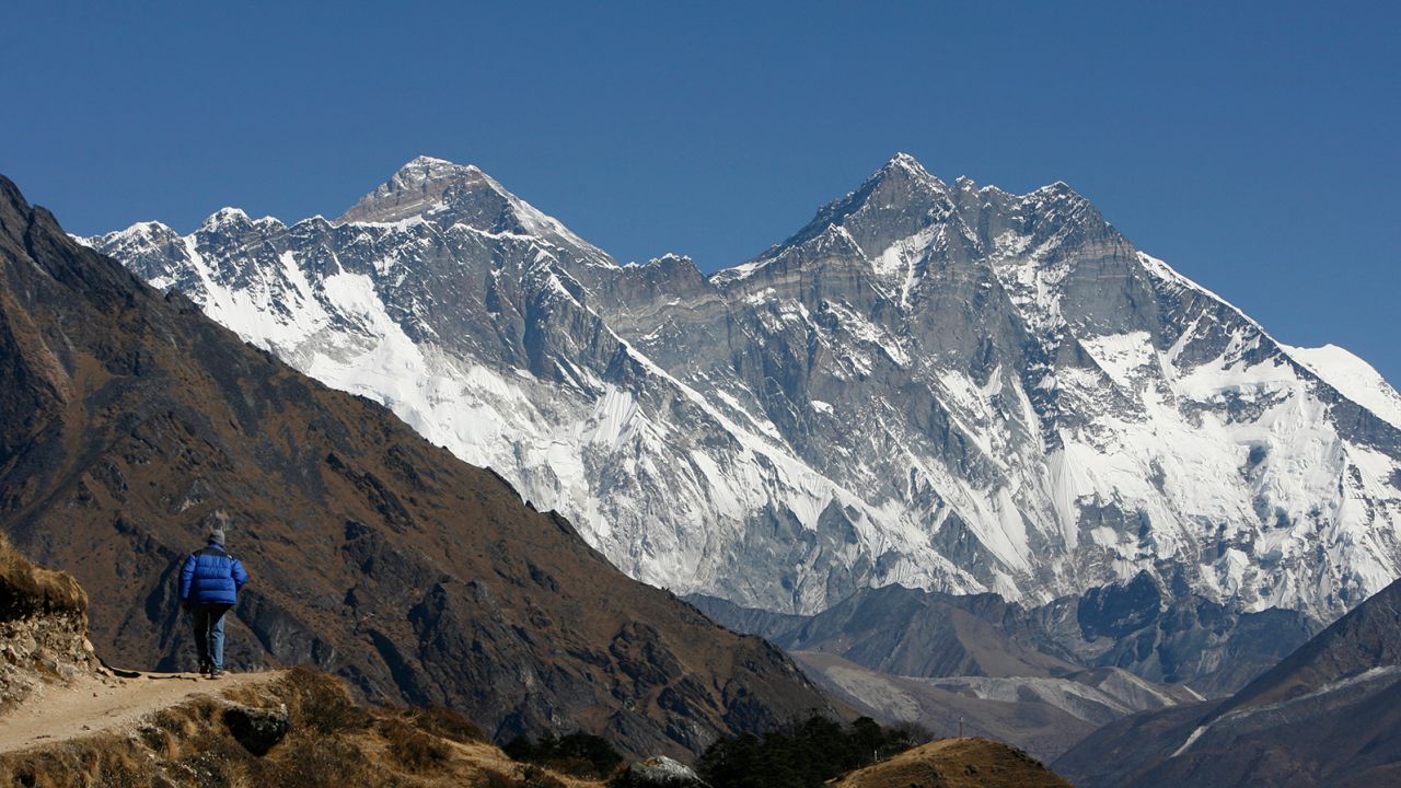A tourist looks at a view of Mt. Everest from the hills of Syangboche in Nepal December 3, 2009.