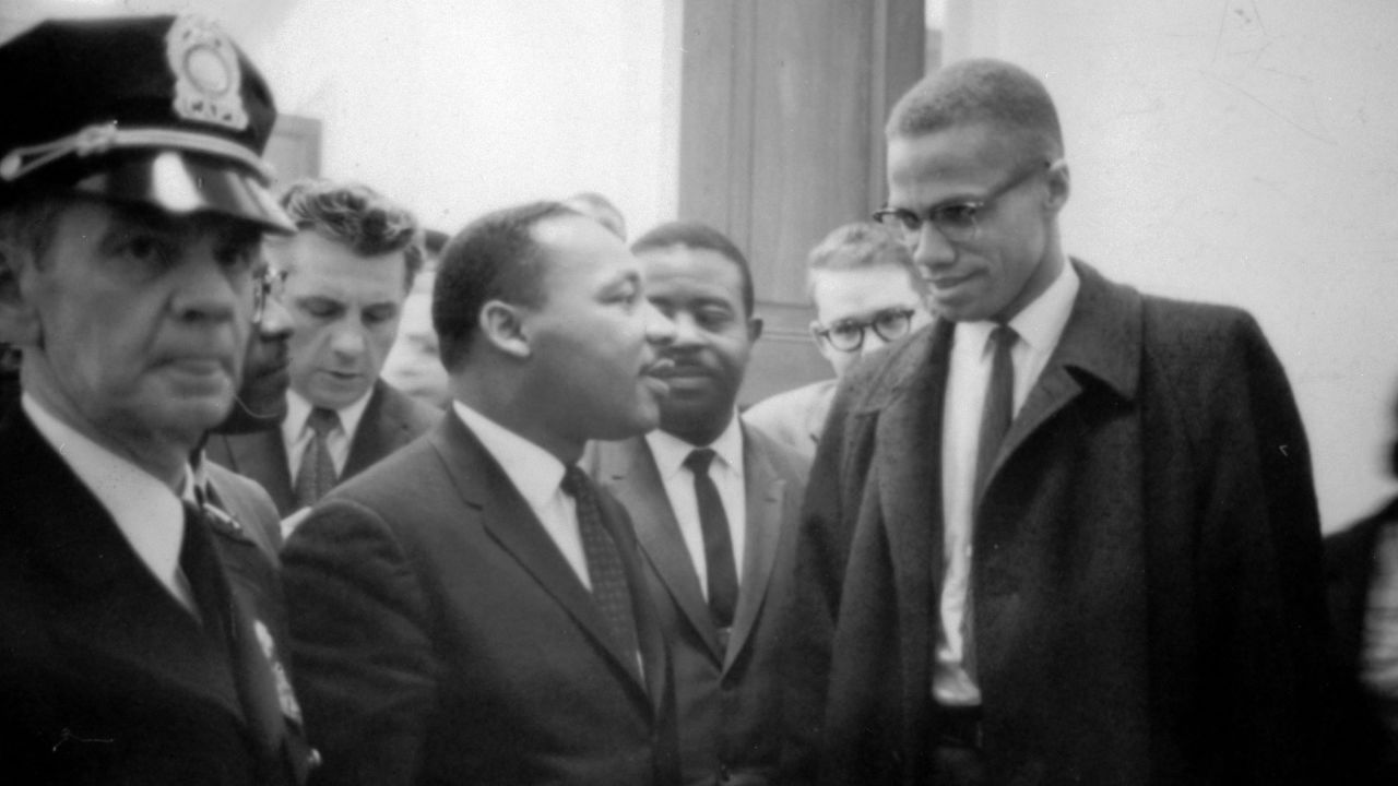 Martin Luther King Jr. and Malcolm X wait for a press conference in March 1964.