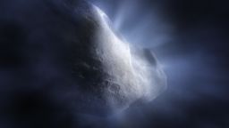 This artist's concept of Comet 238P/Read shows the main belt comet sublimating—its water ice vapourising as its orbit approaches the Sun. This is significant, as the sublimation is what distinguishes comets from asteroids, creating their distinctive tail and hazy halo, or coma. The NASA/ESA/CSA James Webb Space Telescope's detection of water vapour at Comet Read is a major benchmark in the study of main belt comets, and in the broader investigation of the origin of Earth's abundant water. [Image description: Illustration, close up of rocky body of a comet with detailed, cratered surface. Glowing rays emanate from the rocky surface like sunlight through clouds, representing water ice being vapourised by the heat of the Sun.]