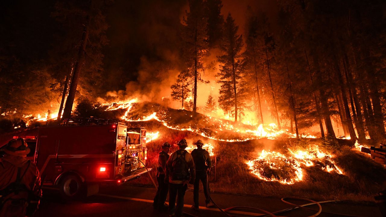 Firefighters try to control a back burn as the Carr fire continues to spread towards the towns of Douglas City and Lewiston near Redding, California, in July 2018.