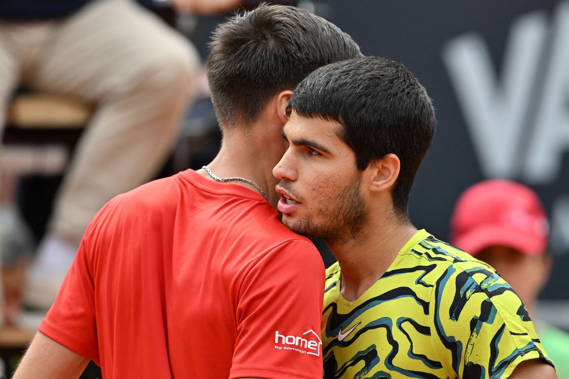 Marozsán and Alcaraz embrace after their match. 