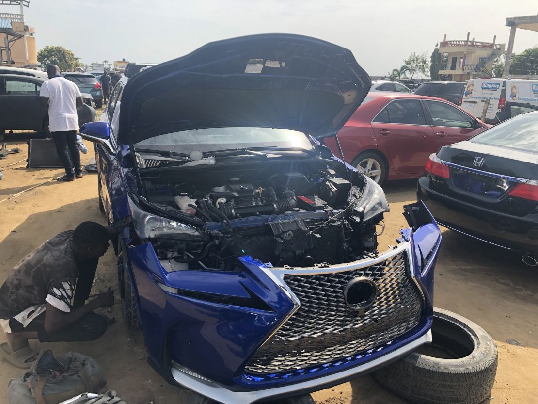 An imported car that has been in an accident is awaiting repair.