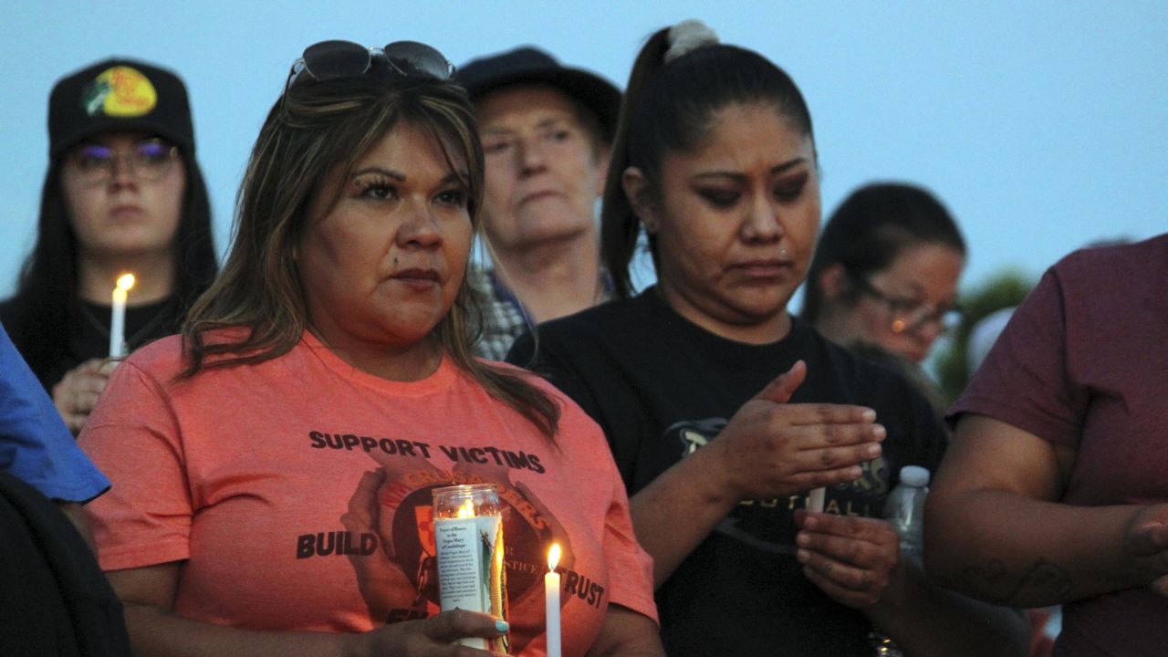 Mourners hold candles Monday during a vigil in Farmington, New Mexico. 