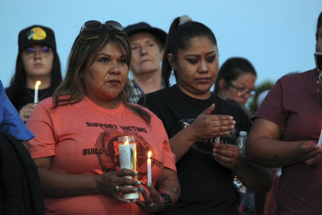Mourners hold candles Monday during a vigil in Farmington, New Mexico. 