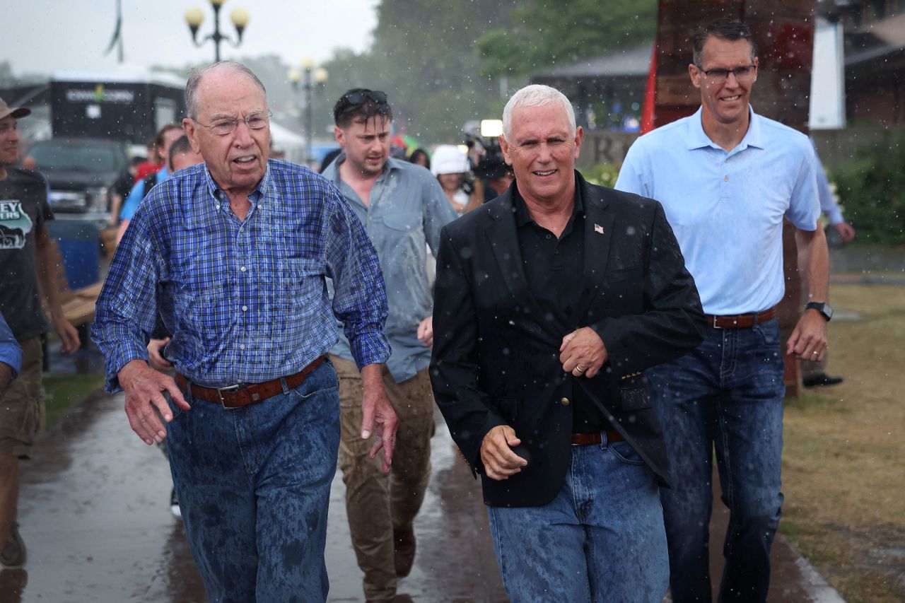 Pence and US Sen. Chuck Grassley, left, tour the Iowa State Fair in Des Moines in August 2022.