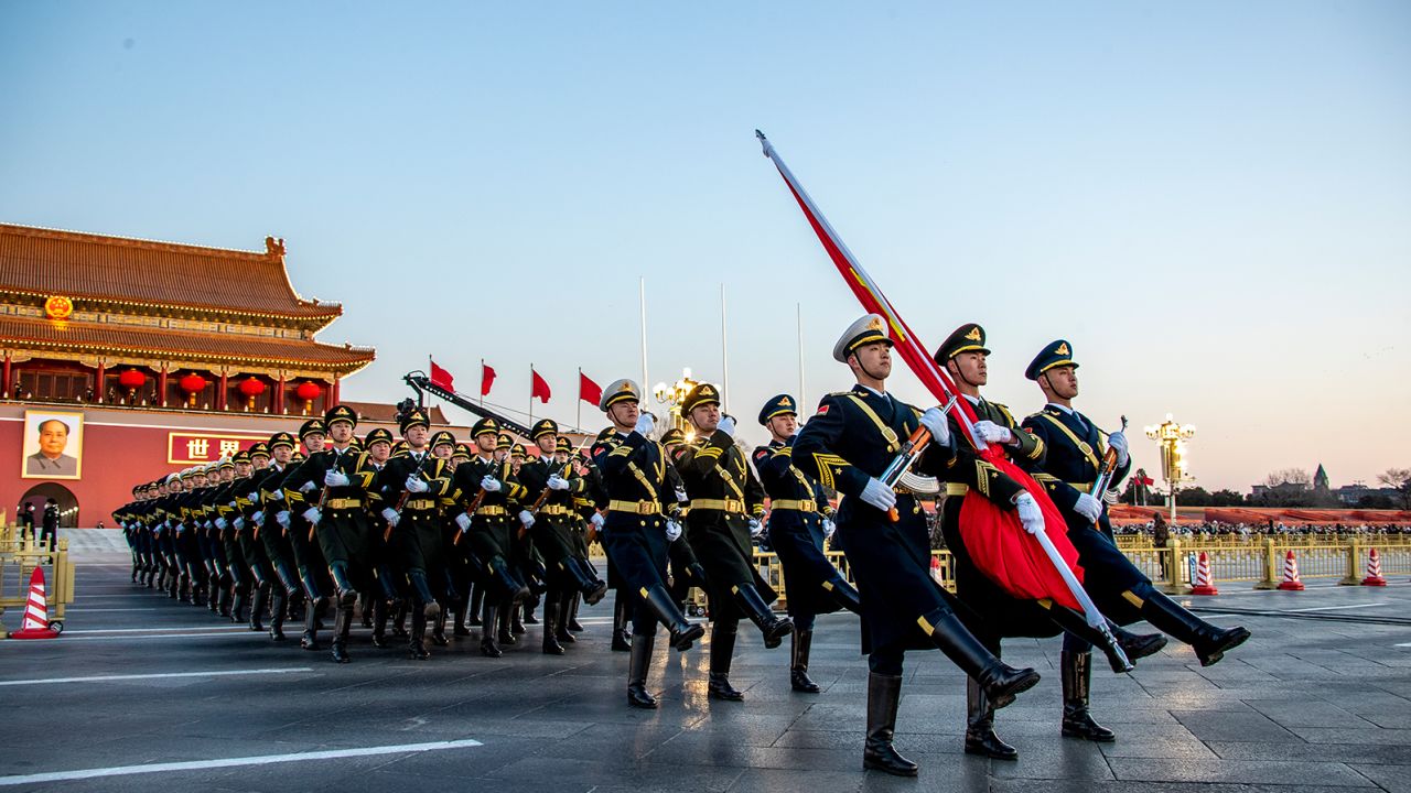 The Guard of Honor of the Chinese People's Liberation Army (PLA) escorts the national flag during a flag-raising ceremony at  Tiananmen Square on January 1, 2023.