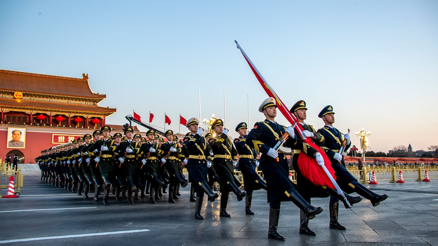 The Guard of Honor of the Chinese People's Liberation Army (PLA) escorts the national flag during a flag-raising ceremony at  Tiananmen Square on January 1, 2023.