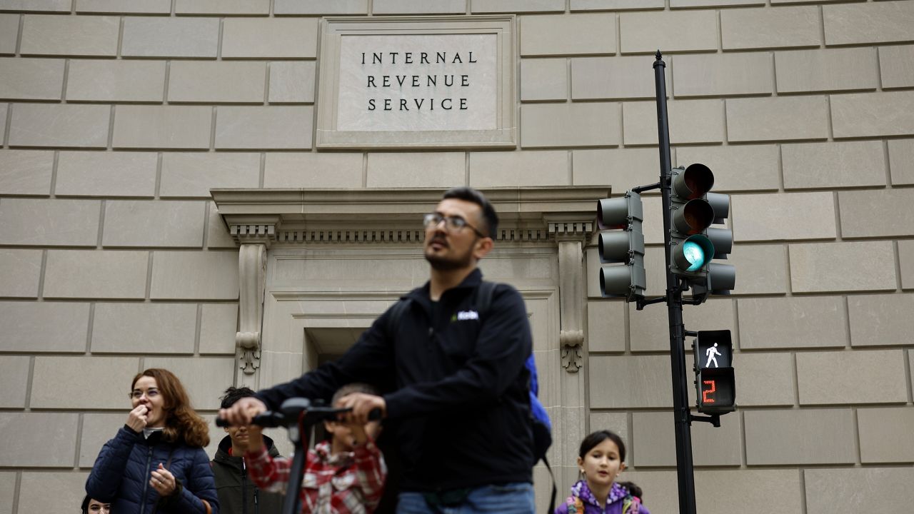 Tourists walk past the headquarters of the Internal Revenue Service near the National Mall on April 7 in Washington, DC.