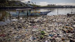 MANILA, PHILIPPINES - APRIL 19: A boat docks at a beach filled with plastic waste at Freedom Island on April 19, 2023 in Paranaque, Metro Manila, Philippines. The Philippines is the largest ocean polluter in the world, contributing a third of the 80% of global ocean plastic that comes from Asian rivers, according to a 2021 report by Oxford University's Our World in Data. Poverty has led the Philippines to become a "sachet economy" that consumes 163 million sachets every day, worsening marine plastic pollution in the region. The trash is piling up on land, clogging coastlines, spilling into the sea, and traveling to remote corners of the globe, as the country fails to meet targets for improved waste management that it signed into law more than two decades ago. According to Greenpeace, global corporations trap low-income customers in developing countries like the Philippines to buy - and buy often - fast-moving consumer goods in small quantities packaged in cheap, disposable plastics as part of a strategy to drive market share and profits. Break Free From Plastic's 2022 Brand Audit Report revealed that the Coca-Cola Company, Philip Morris International, Universal Robina Corporation (URC), Philippine Spring Water Resources, Inc., and Japan Tobacco International are the worst plastic polluters in the country. Globally, Coca-Cola also leads the list for five years in a row, followed by PepsiCo, Nestle, Mondelez International, and Unilever -- all consistently part of the annual top 10. (Photo by Ezra Acayan/Getty Images)