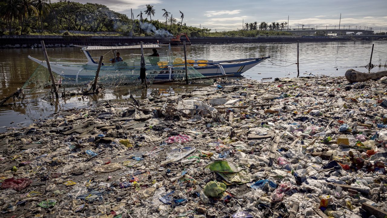 A boat docks at a beach filled with plastic waste at Freedom Island in Paranaque, the Philippines. 